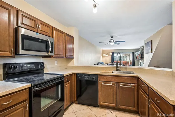 a kitchen with stainless steel appliances granite countertop a sink stove and microwave