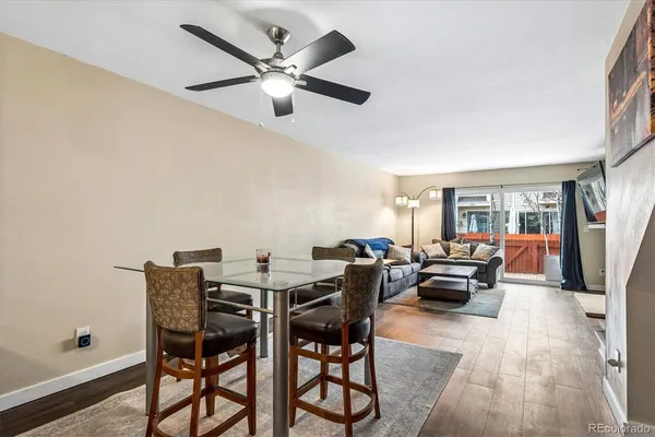 a dining room with furniture a chandelier and wooden floor