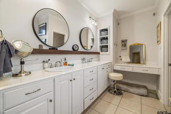 a bathroom with a granite countertop double vanity sink and a mirror