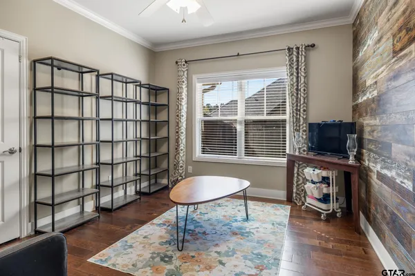 a living room with furniture a window and a flat screen tv