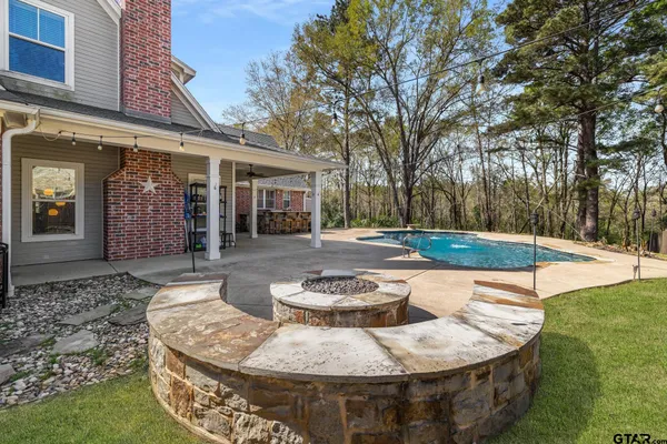 a view of a swimming pool with a patio