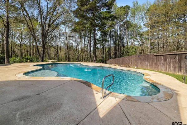 a view of a patio with table and chairs with wooden fence and plants