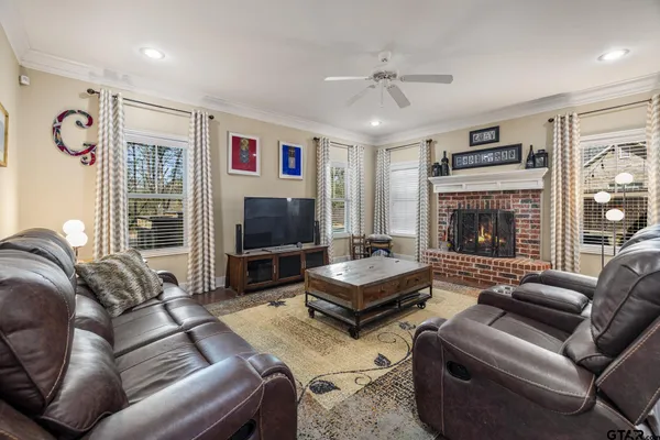a living room with furniture fireplace and flat screen tv