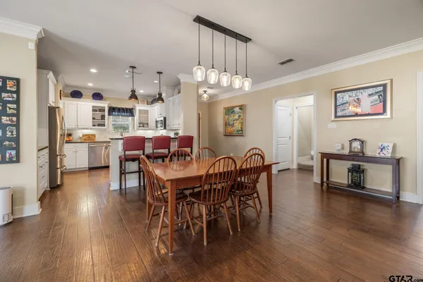a view of a dining room with furniture and wooden floor