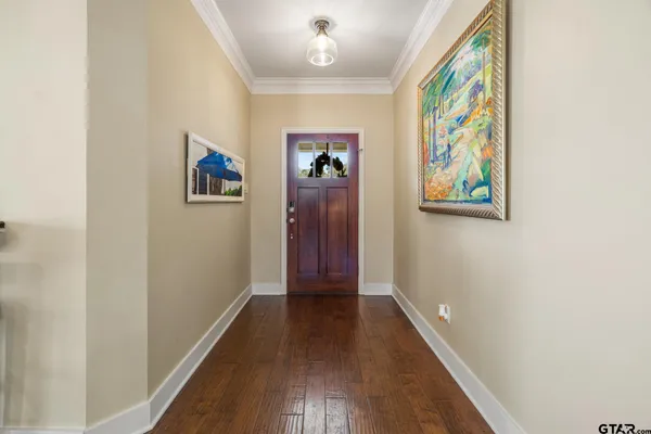 a view of a hallway with wooden floor