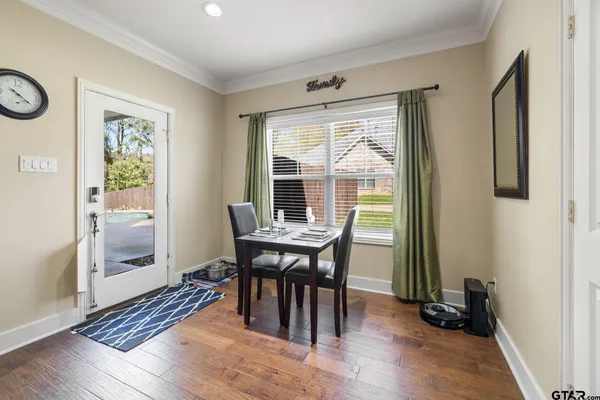 a view of a dining room with furniture window and wooden floor
