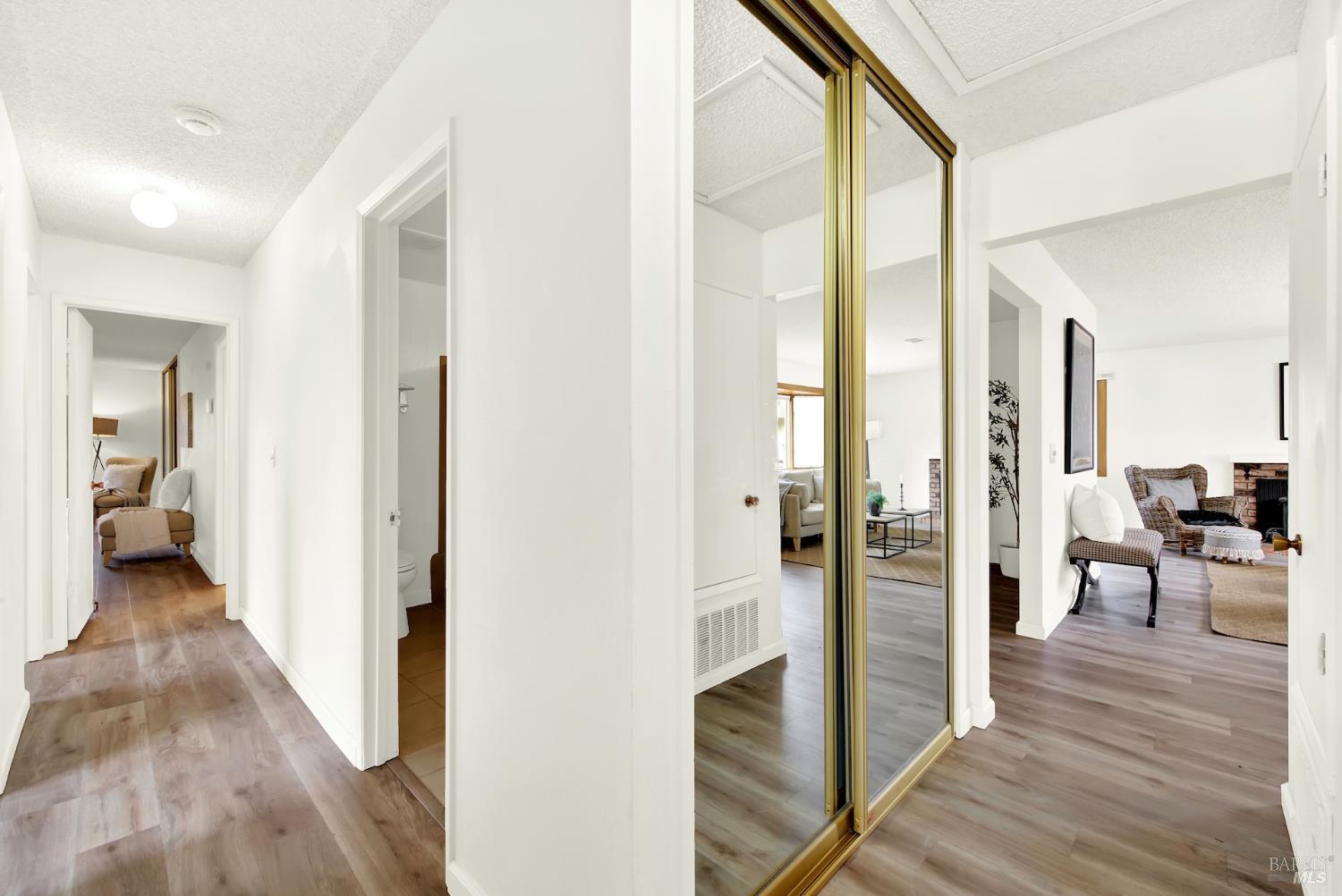 2219 Channing Court Fairfield, CA 94533 - Photo 42 of 81 a view of a hallway with wooden floor and a living room