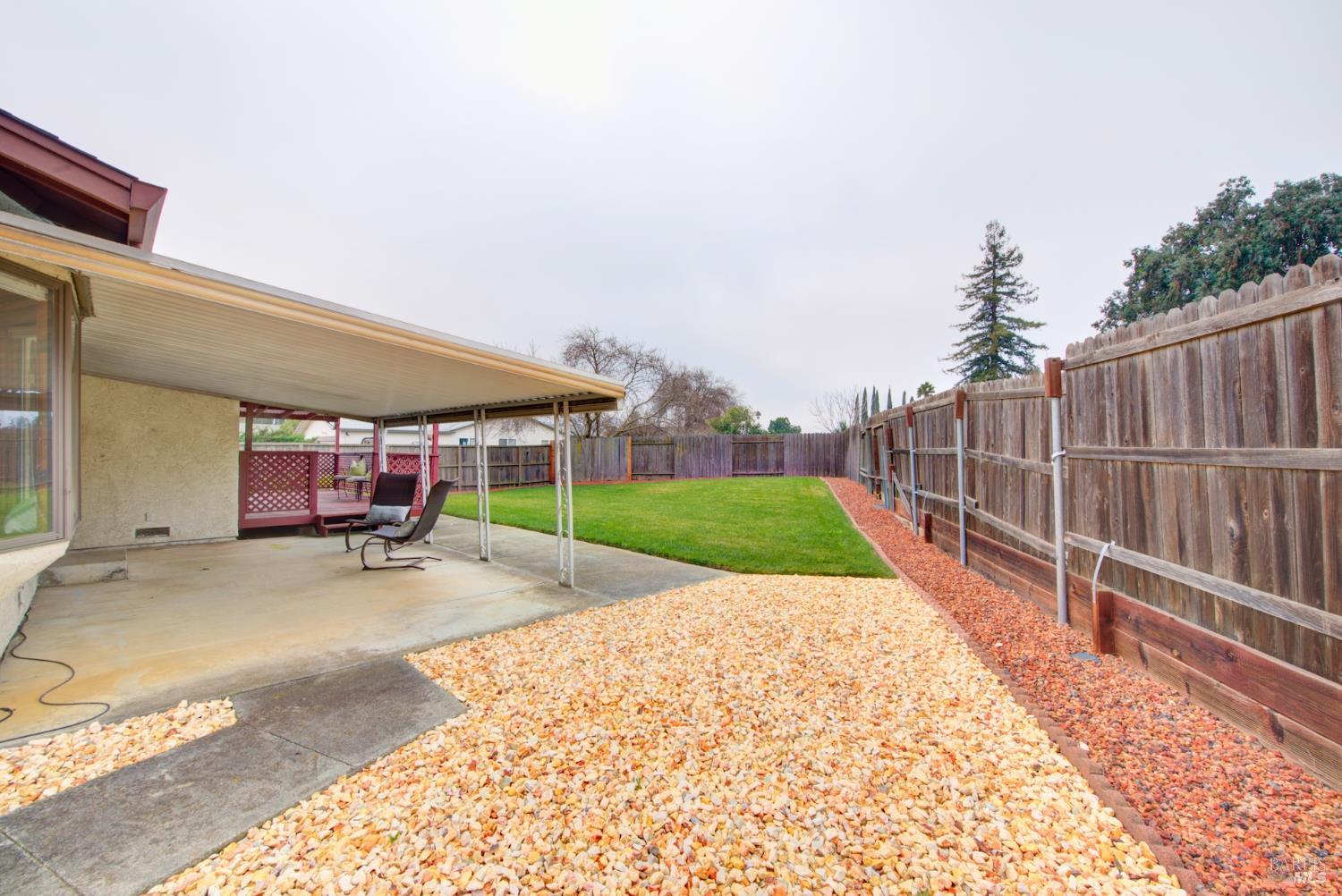 2219 Channing Court Fairfield, CA 94533 - Photo 70 of 81 a view of a backyard with table and chairs under an umbrella