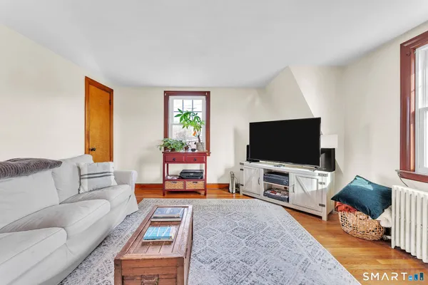 a dining room with furniture and wooden floor