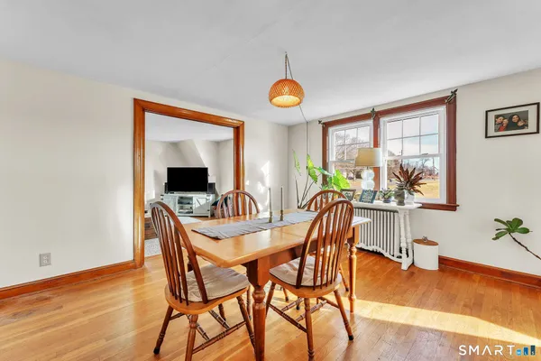 a kitchen with a stove a refrigerator and a view of living room