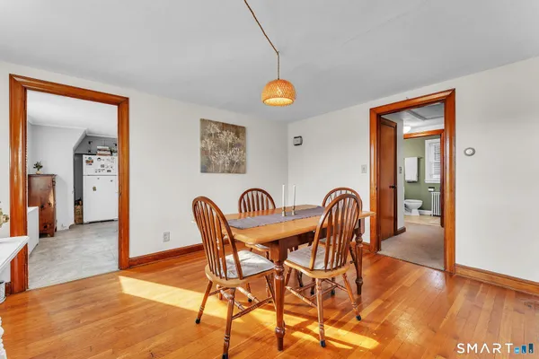 a kitchen with stainless steel appliances granite countertop a sink a stove and a wooden floor