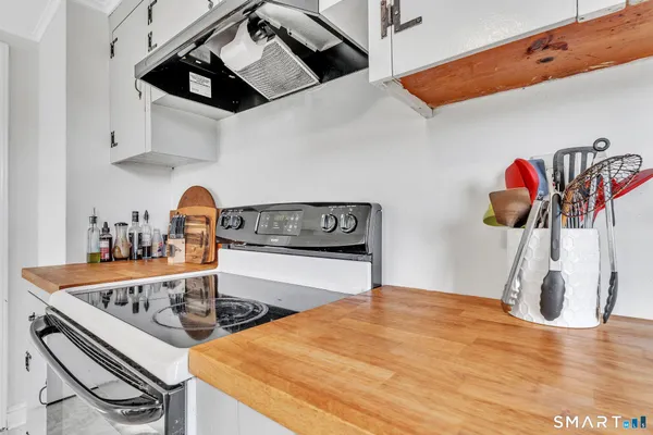 a view of a house with barbeque and sitting area