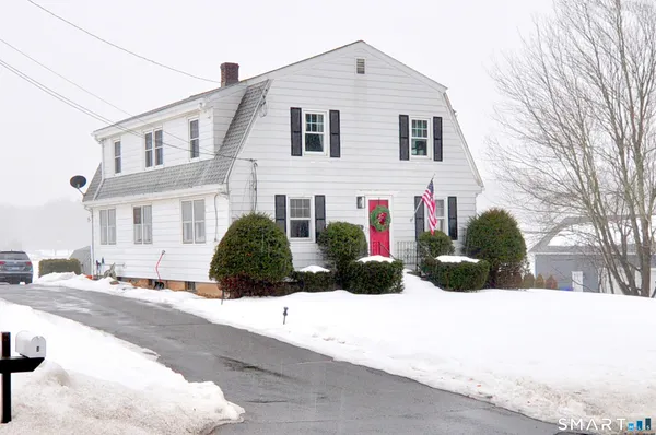 a view of a white house with a yard