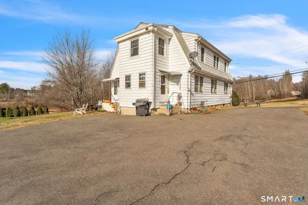 a view of a porch with plants and wooden fence