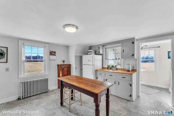 a room with furniture a window and wooden floor