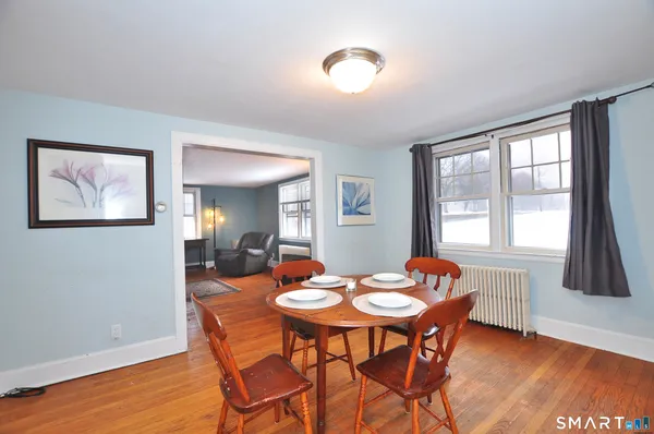 a view of a dining room with furniture window and wooden floor