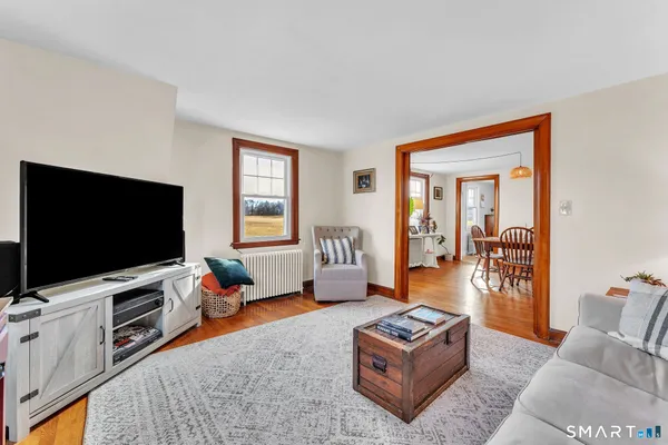 a view of a dining room with furniture and wooden floor