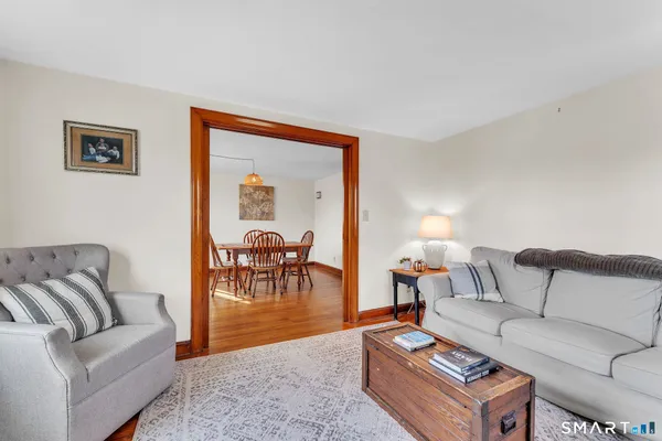 a room with furniture a window and wooden floor
