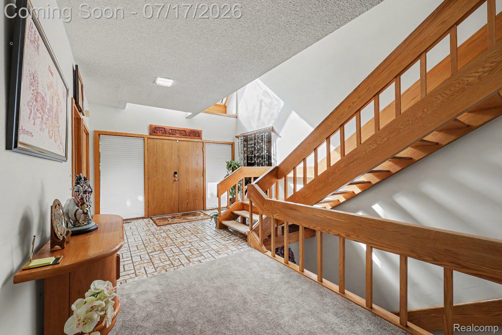 5685 Paint Valley Drive Rochester, MI 48306 - Photo 18 of 66 Entry foyer with a prominent wood staircase featuring open risers and matching wood railings