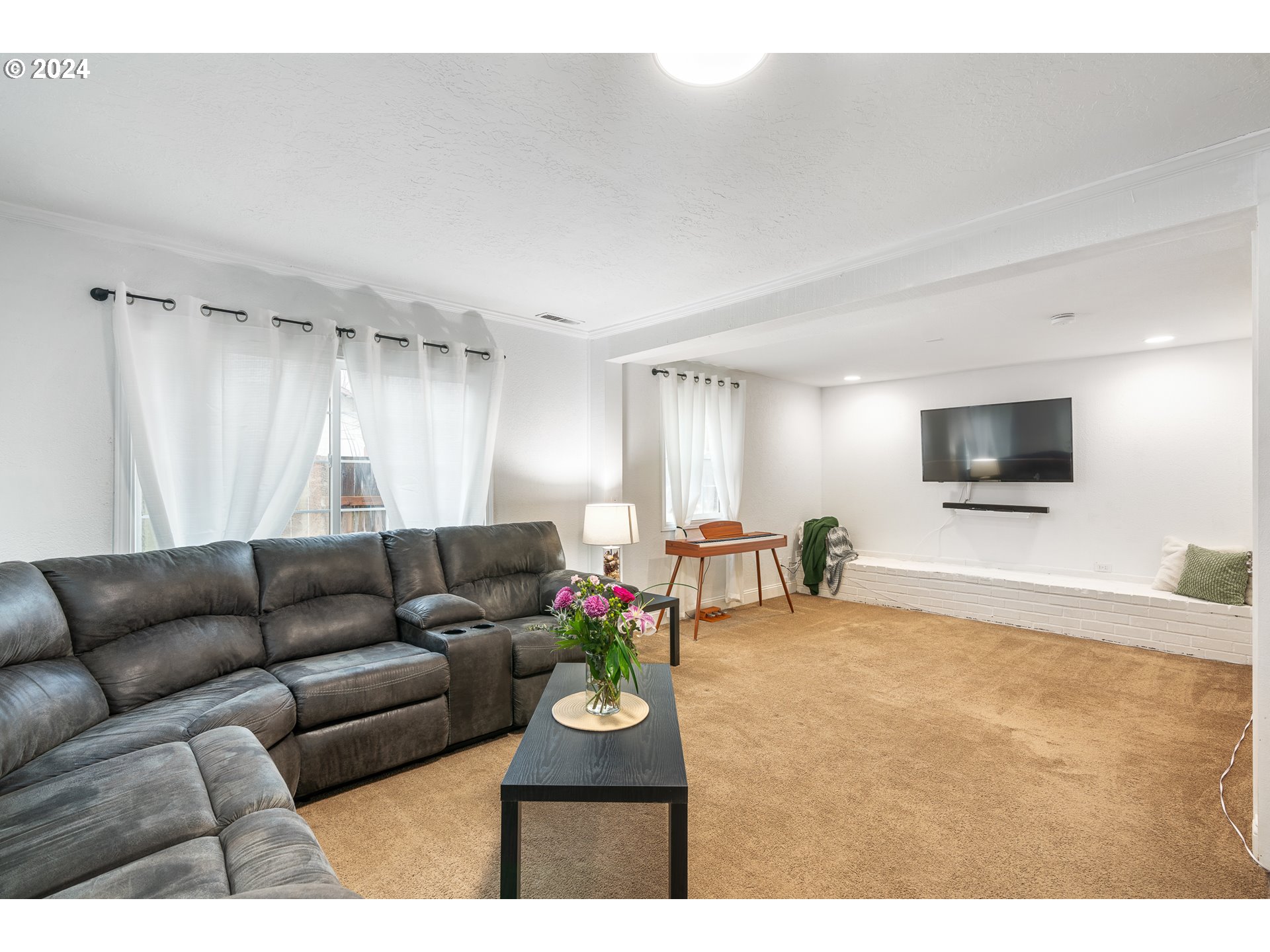 3305 Northwest Glencoe Road Hillsboro, OR 97124 - Photo 2 of 36 a living room with furniture and a flat screen tv