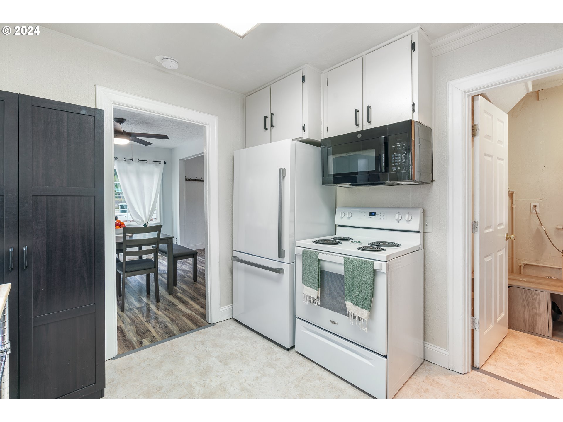 3305 Northwest Glencoe Road Hillsboro, OR 97124 - Photo 10 of 36 a kitchen with white cabinets and stainless steel appliances