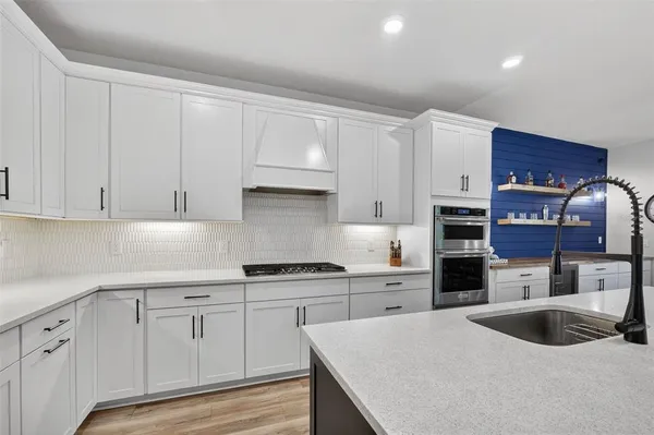 a bathroom with a sink a toilet and a large mirror