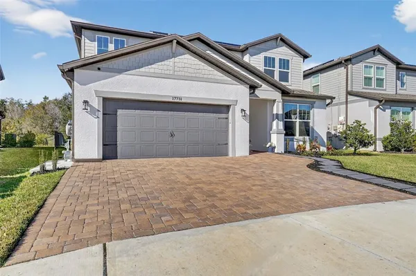a front view of a house with a yard and garage