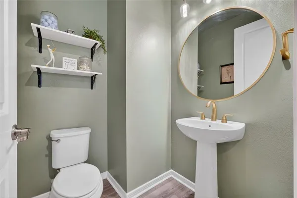 a bathroom with double vanity sinks a vanity a lamp and a mirror