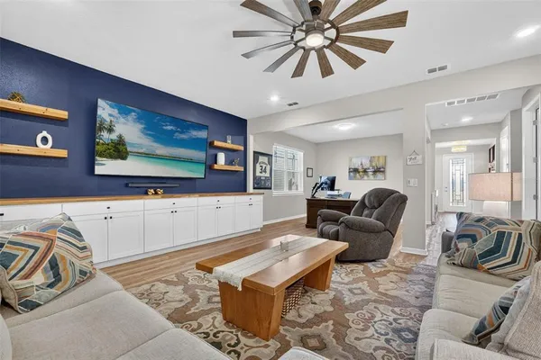 a living room with furniture and a view of kitchen