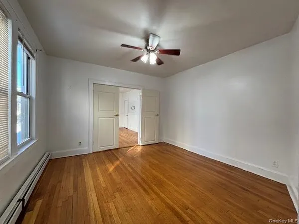 wooden floor in an empty room with a window