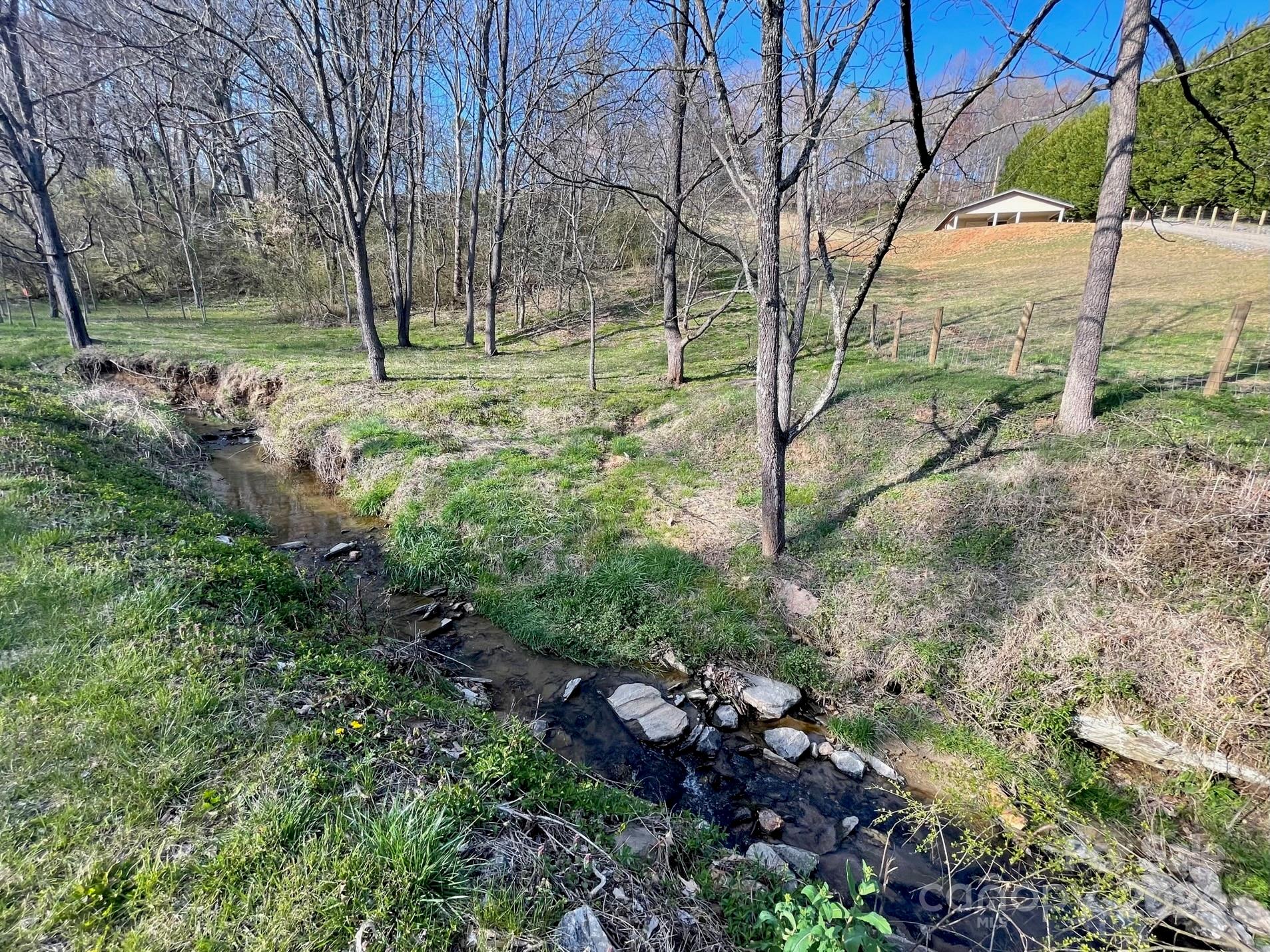 50 Glance Cove Road Clyde, NC 28721 - Photo 20 of 27 a backyard of a house with lots of green space