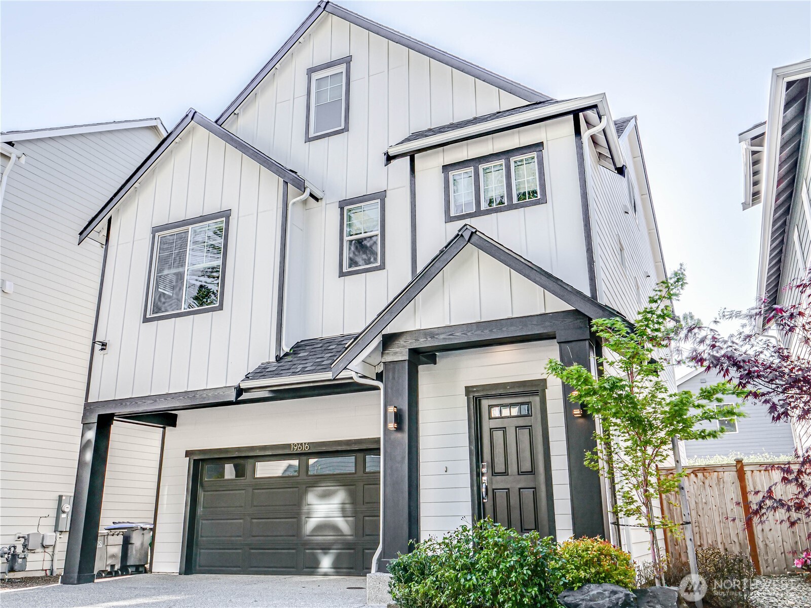 a view of house with front door and potted plants