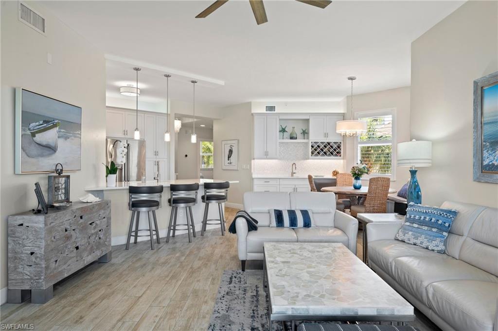 450 Launch Circle, Unit 201 Naples, FL 34108 - Photo 11 of 43 a living room with furniture and wooden floor