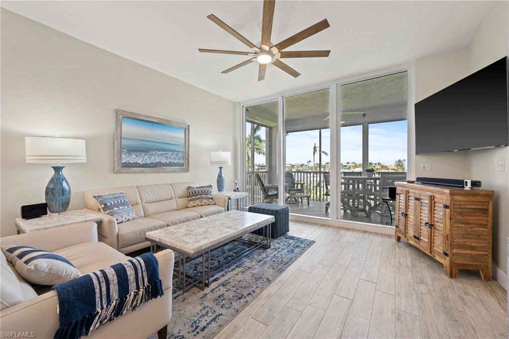 450 Launch Circle, Unit 201 Naples, FL 34108 - Photo 12 of 43 a living room with furniture and a large window