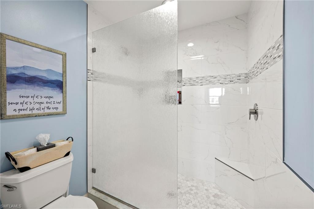 450 Launch Circle, Unit 201 Naples, FL 34108 - Photo 17 of 43 a bathroom with a shower and toilet