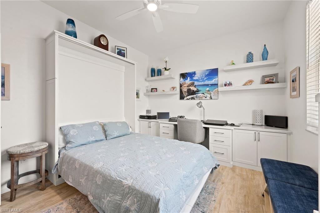 450 Launch Circle, Unit 201 Naples, FL 34108 - Photo 20 of 43 a bed room with a bed and a tv