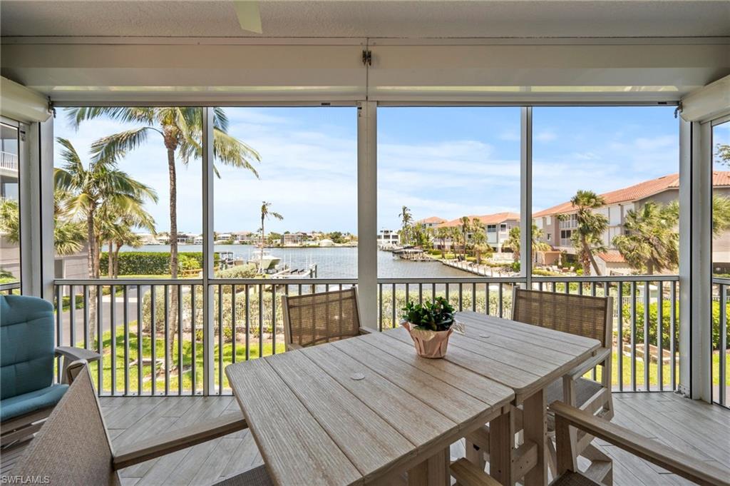 450 Launch Circle, Unit 201 Naples, FL 34108 - Photo 26 of 43 a view of a balcony with lake and mountain view