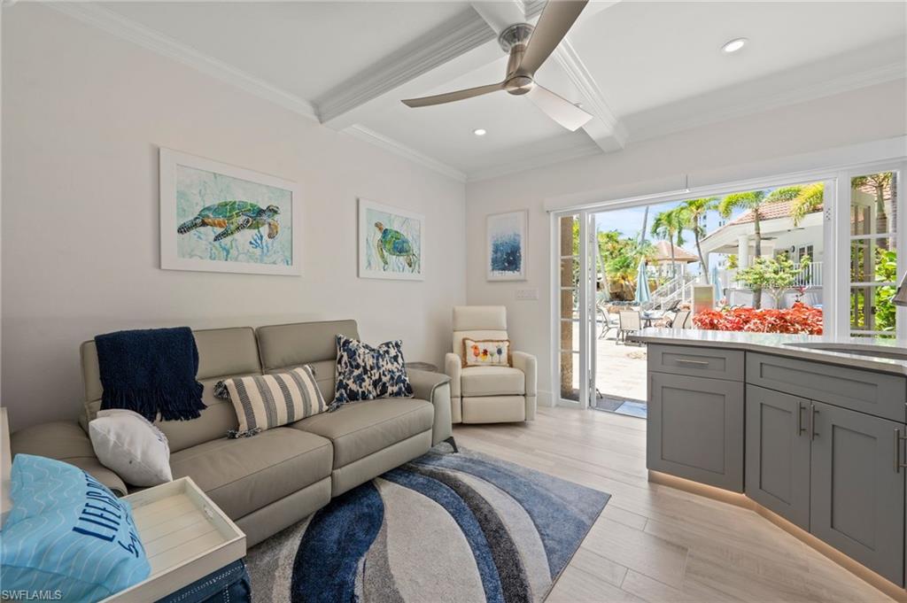 450 Launch Circle, Unit 201 Naples, FL 34108 - Photo 37 of 43 a living room with furniture and a large window