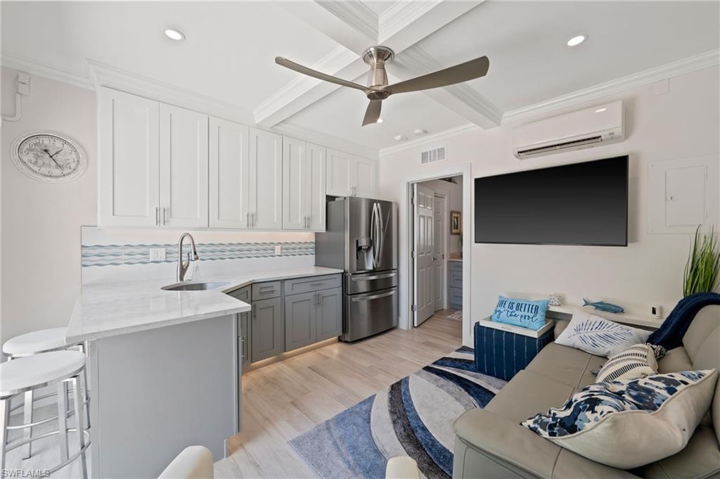 450 Launch Circle, Unit 201 Naples, FL 34108 - Photo 38 of 43 a kitchen with stainless steel appliances granite countertop a sink a stove and a refrigerator