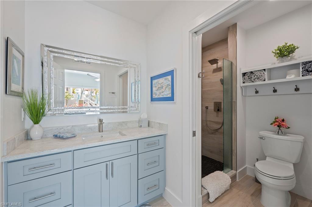 450 Launch Circle, Unit 201 Naples, FL 34108 - Photo 40 of 43 a bathroom with a sink a toilet and shower