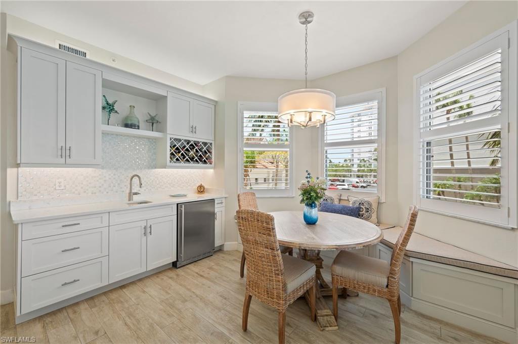 450 Launch Circle, Unit 201 Naples, FL 34108 - Photo 4 of 43 a view of a dining room with furniture windows and wooden floor