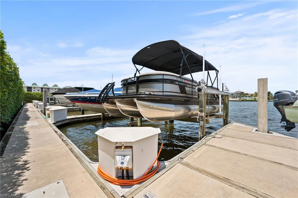 450 Launch Circle, Unit 201 Naples, FL 34108 - Photo 41 of 43 a roof deck with table and chairs a barbeque
