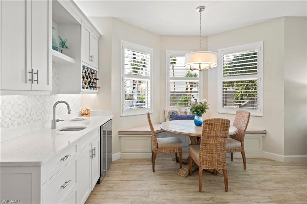 450 Launch Circle, Unit 201 Naples, FL 34108 - Photo 8 of 43 a view of a dining room with furniture window and outside view