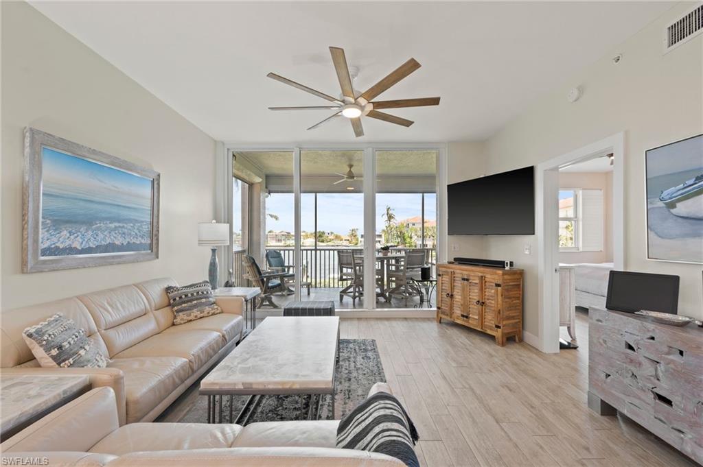 450 Launch Circle, Unit 201 Naples, FL 34108 - Photo 9 of 43 a living room with furniture and a flat screen tv