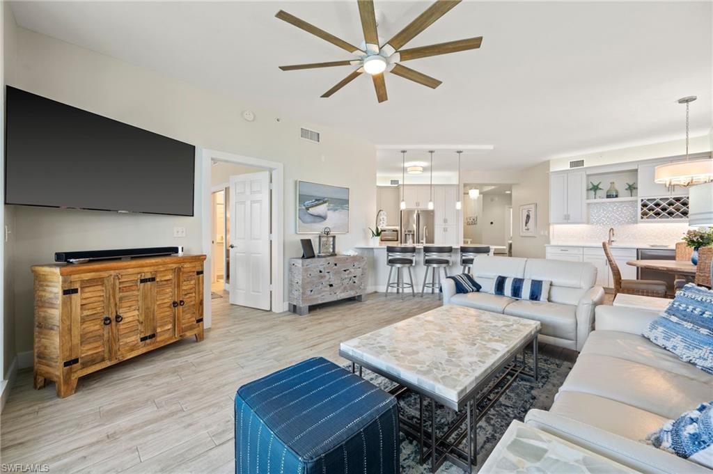 450 Launch Circle, Unit 201 Naples, FL 34108 - Photo 10 of 43 a living room with furniture and a table