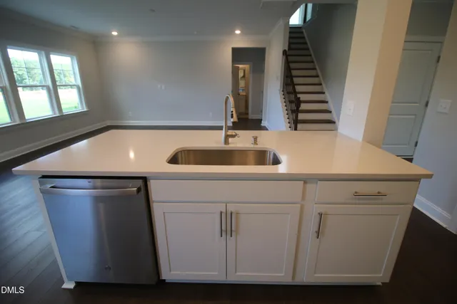 a kitchen with appliances a refrigerator and wooden floor