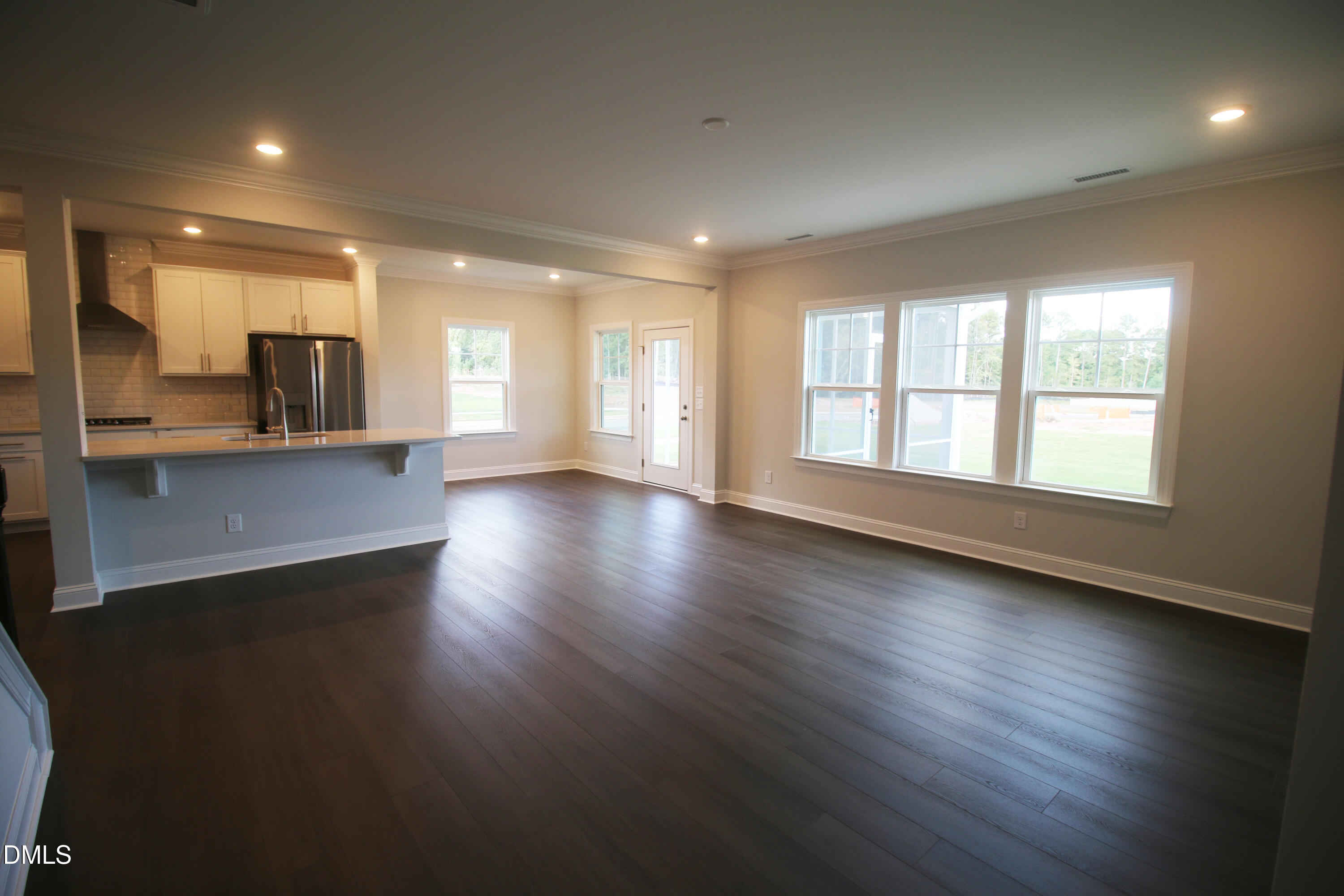 1201 Cosmic Drive Durham, NC 27703 - Photo 12 of 51 an empty room with wooden floor and windows