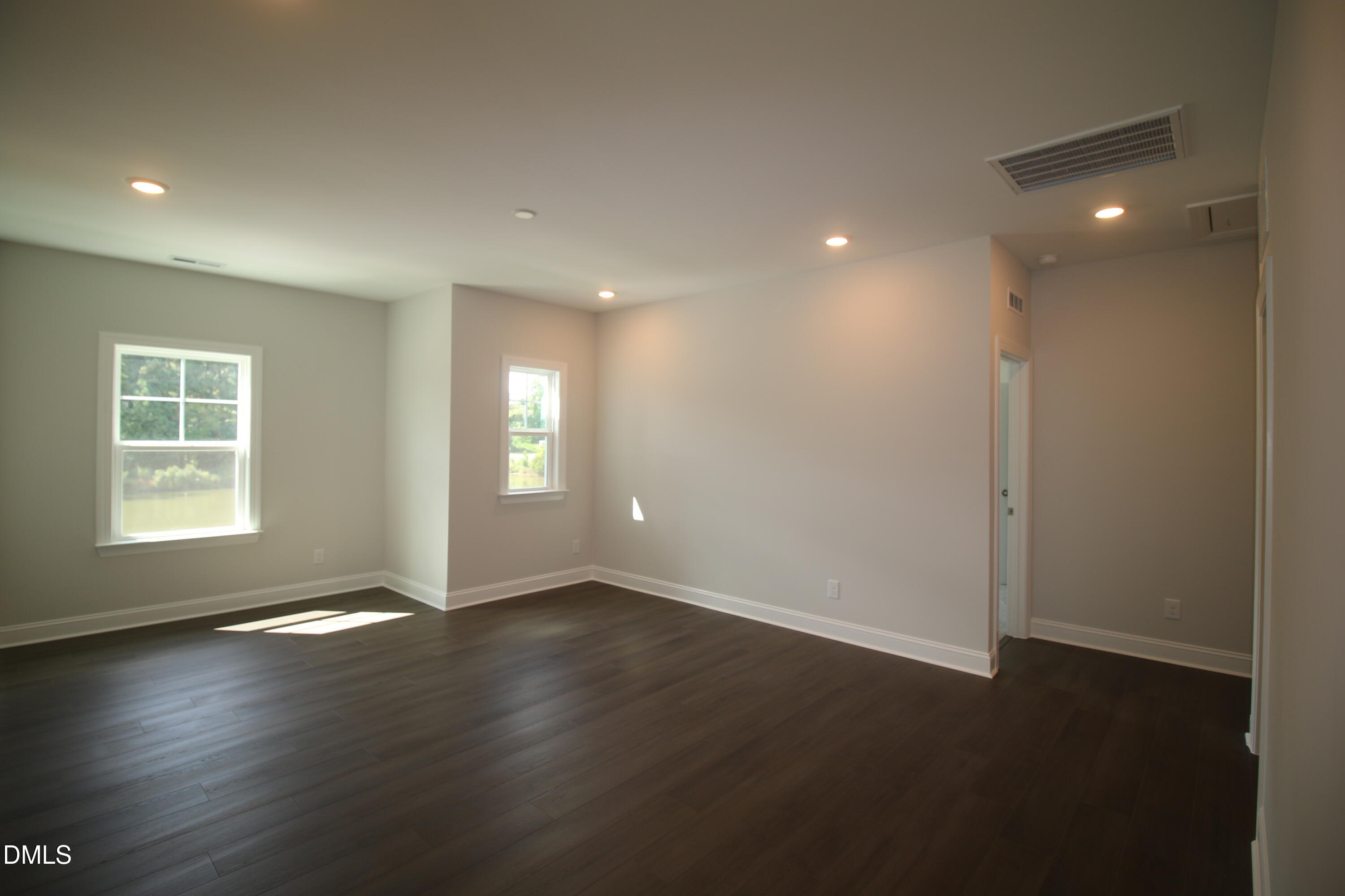 1201 Cosmic Drive Durham, NC 27703 - Photo 28 of 51 an empty room with wooden floor and windows