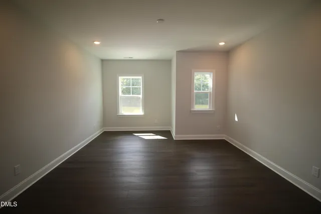 a room with a sink cabinets and a window