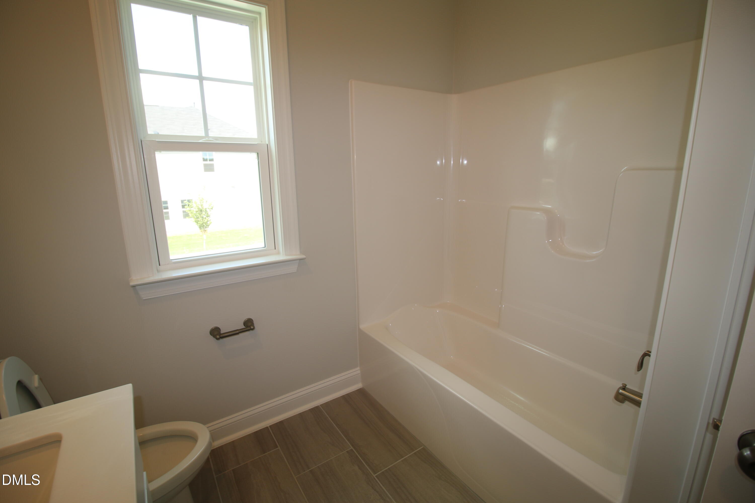 1201 Cosmic Drive Durham, NC 27703 - Photo 33 of 51 a bathroom with a bathtub and window